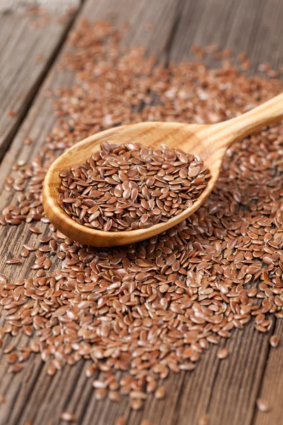 Natural raw flax seeds nutritious food in spoon on wooden vintag — Stock Photo, Image