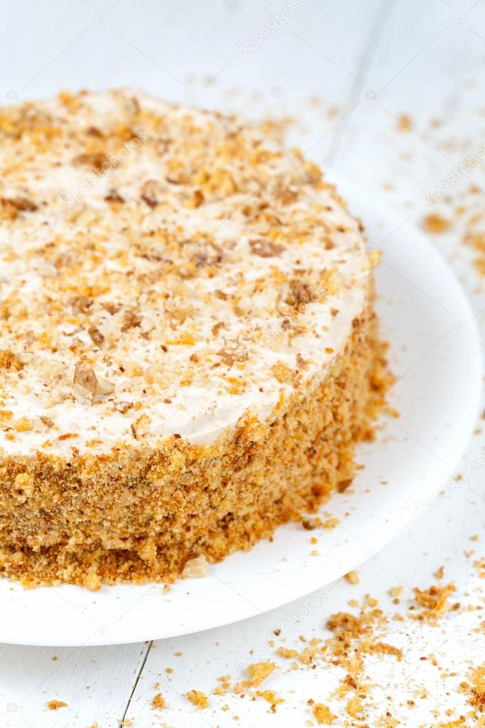 Tasty carrot cake with pastry cream and walnut crumbs