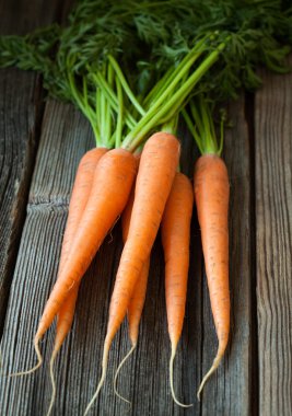 Bunch of carrots healthy vegetarian raw snack on vintage wooden background