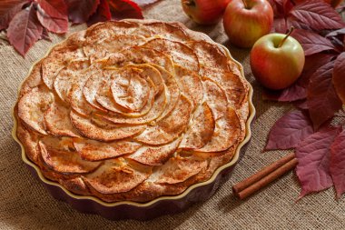 Homemade gourmet apple pie baked sweet traditional dessert with cinnamon and apples on vintage background.