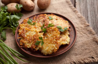 Potato pancakes or latke traditional homemade fried vegetable food recipe. Healthy organic vegan food.