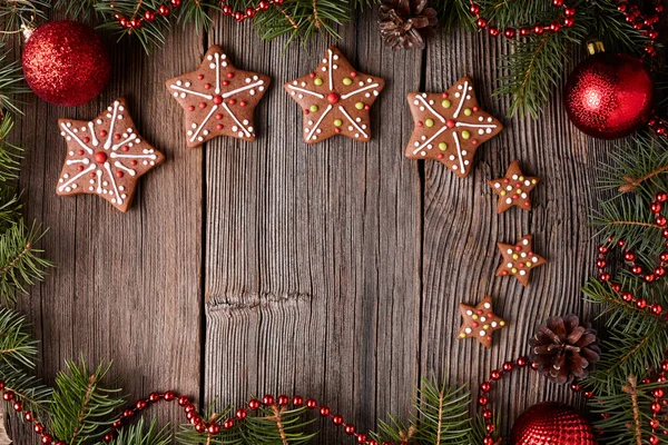 Gingerbread star cookies christmas composition in new year tree decorations frame on vintage wooden table background. Empty space for designer text. Top view. Traditional homemade holiday recipe. — Stock Photo, Image