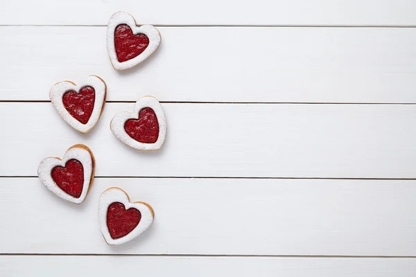 Heart shaped cookies with jam for Valentines day on white wooden background — Zdjęcie stockowe