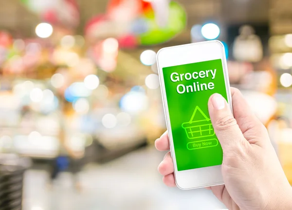 Hand holding mobile with grocery online — Stock Photo, Image