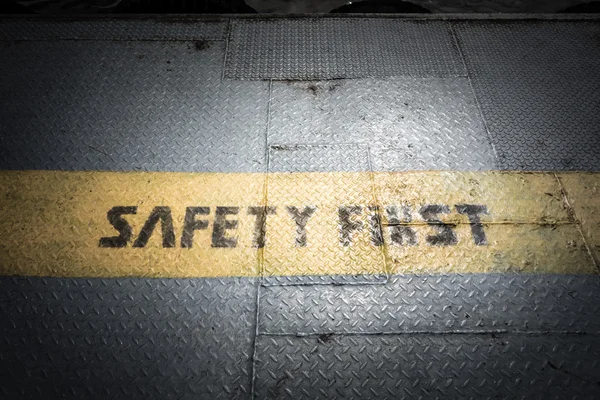 Safety first sign on yellow line — Stock Photo, Image