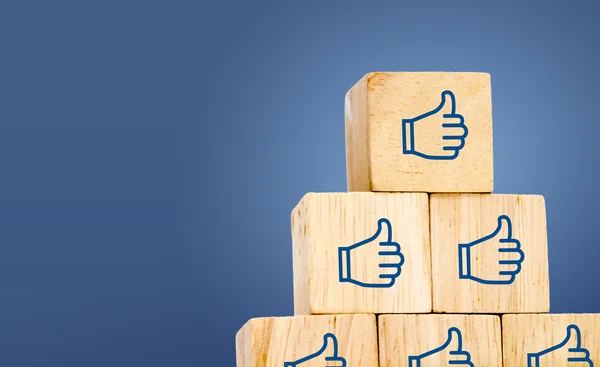 Thumb up icon on wood cubes — Stock Photo, Image