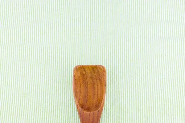 Ξύλινο κουτάλι στην Πράσινη λουρίδα τραπεζομάντιλο — Φωτογραφία Αρχείου