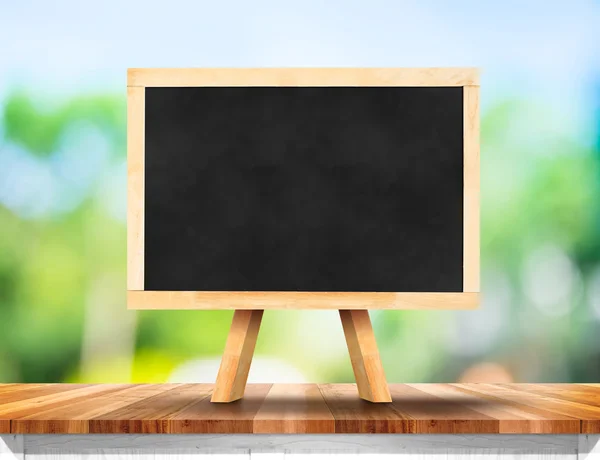 Blank blackboard on wood table — Stock Photo, Image