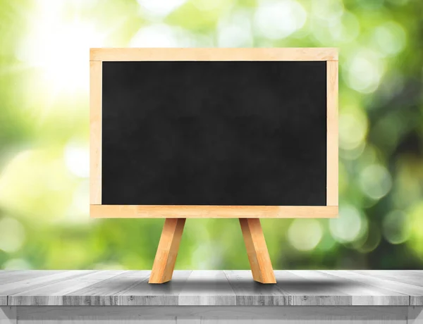 Blank blackboard on white wood table