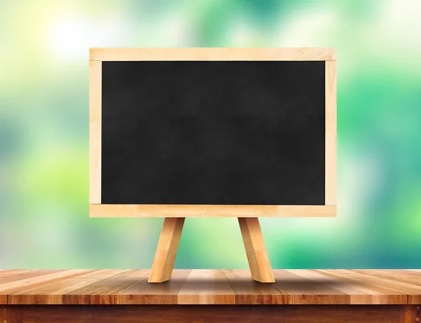 Blank blackboard on wood table — Stock Photo, Image