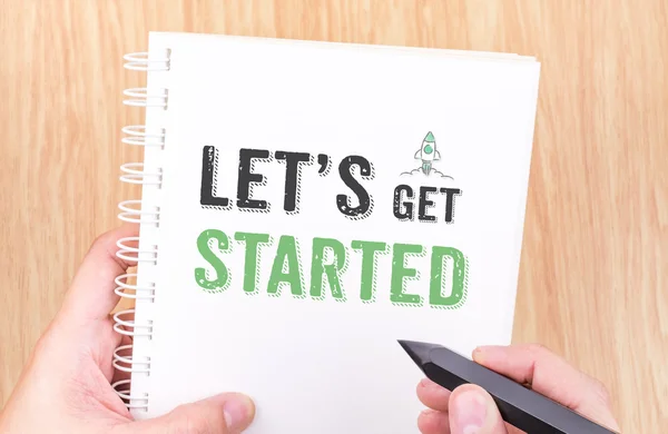 Let's get started word on white ring binder notebook with hand h — Stock Photo, Image