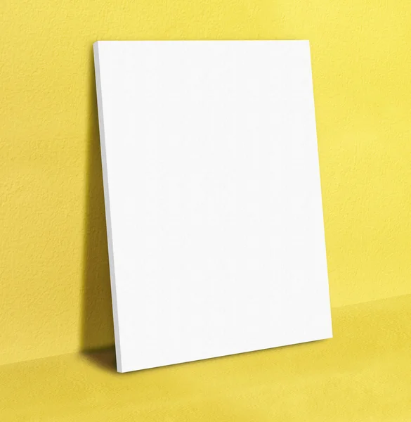 Blank white poster canvas frame leaning at yellow concrete paint — Stock Photo, Image