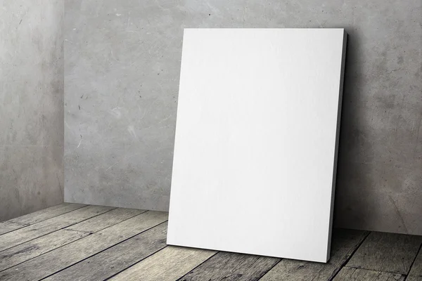 Blank white poster frame leaning at grunge grey concrete wall an — Stock Photo, Image