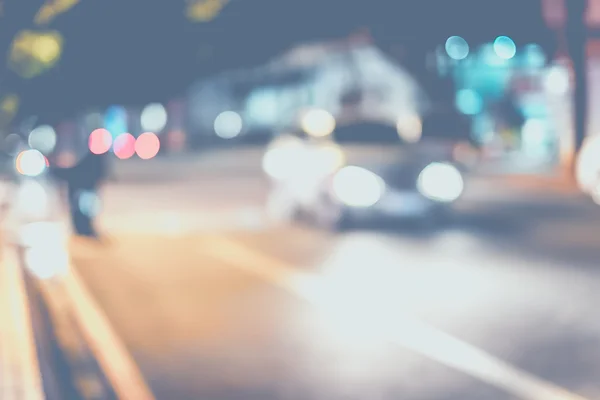 Fondo borroso, Calle nocturna con luz del coche en la carretera . —  Fotos de Stock