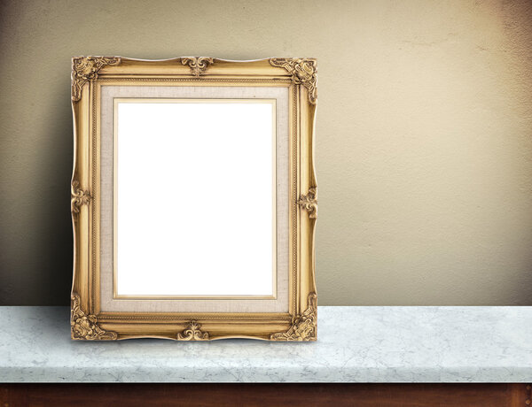 Blank Gold victorian picture frame on marble table at yellow concrete wall,Template mock up for adding your design and leave space beside frame for adding more text