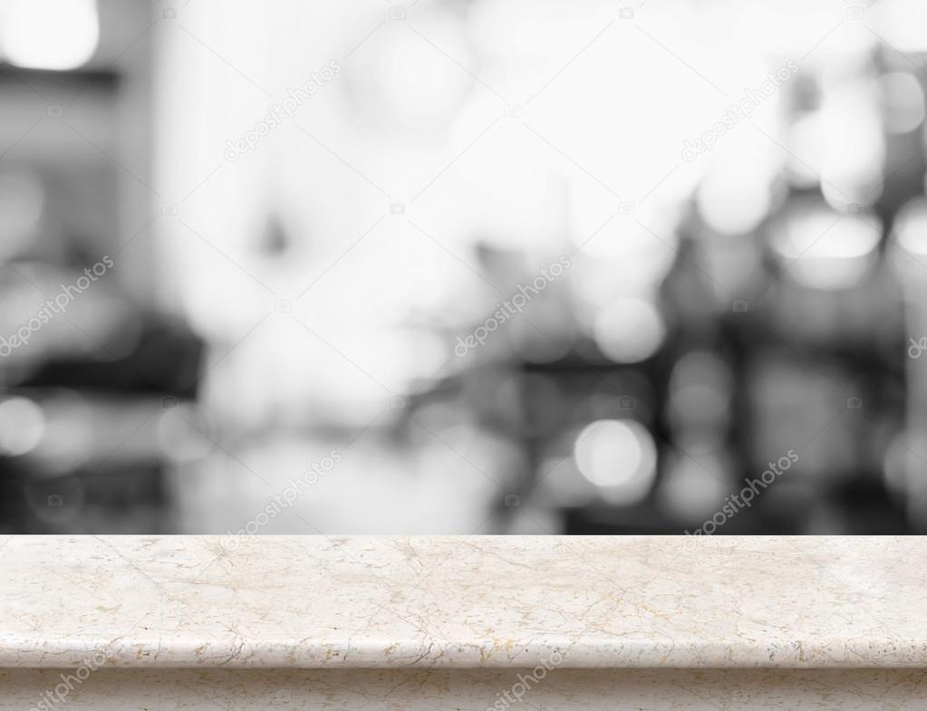 Empty beige marble table top with black and white people siting 