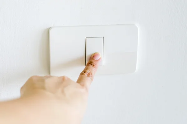 Finger press on light button — Stock Photo, Image