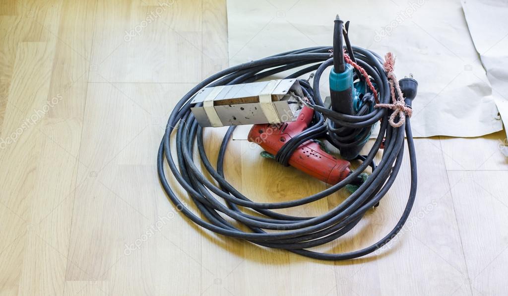 Drill and wire on wood parquet floor