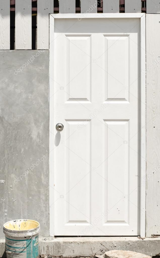 White door with cement wall at under construction site