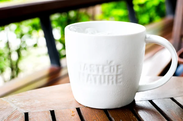 Λευκό κεραμικό κούπα με σφραγίδα λέξη "Γεύση της φύσης" στο καφέ sh — Φωτογραφία Αρχείου