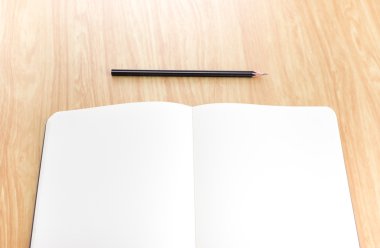 blank open notebook with black pencil on wood table,Business tem clipart