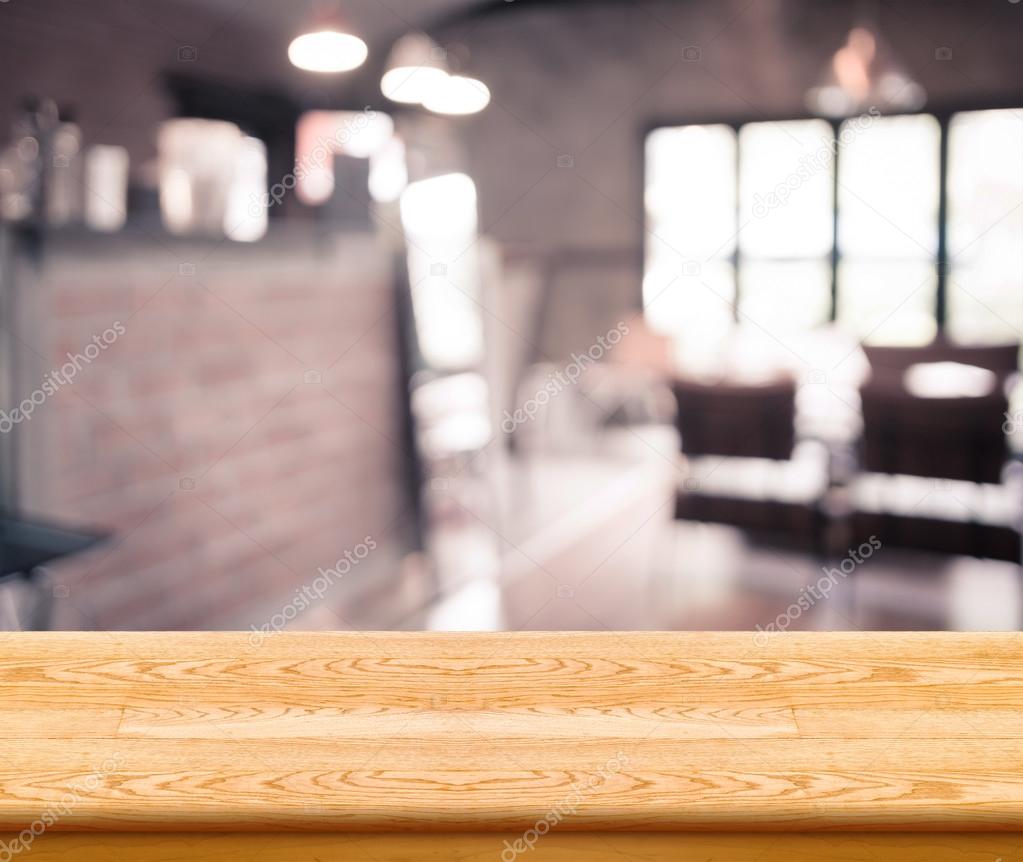 Empty wood table top with coffee shop blur with bokeh background