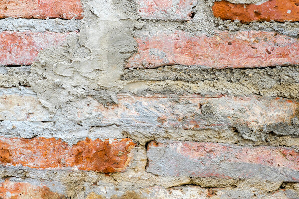 Old orange brick wall with crack cement.