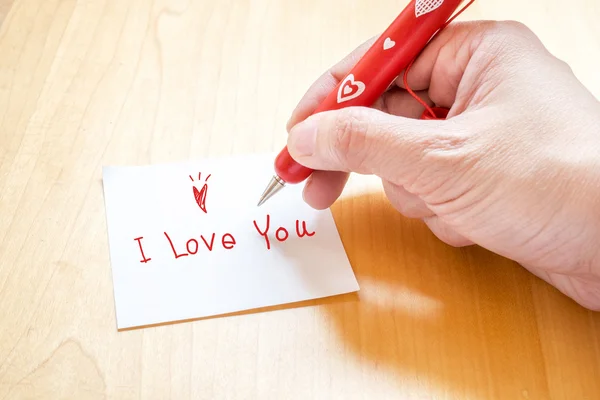 Mão segurando caneta vermelha — Fotografia de Stock
