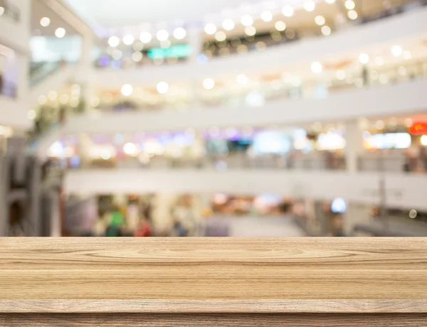 Table and blurred department store background — Stock Photo, Image