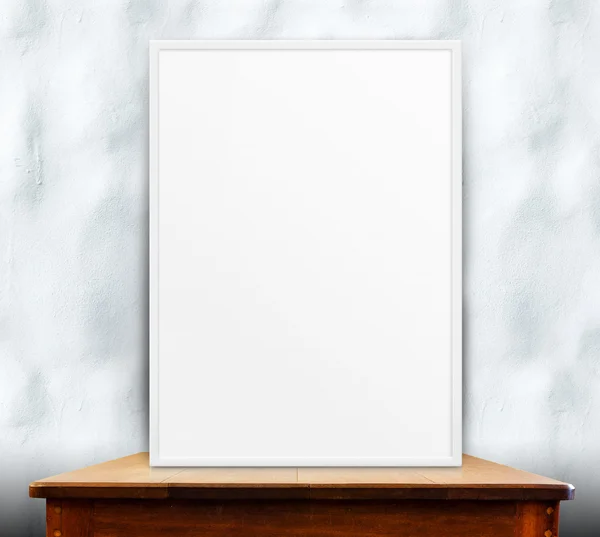 Empty white frame on wooden table — Stock Photo, Image