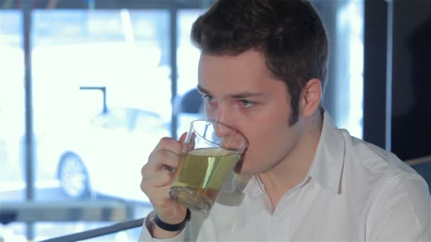 Close up of man drinks tea at the cafe — Stock Video