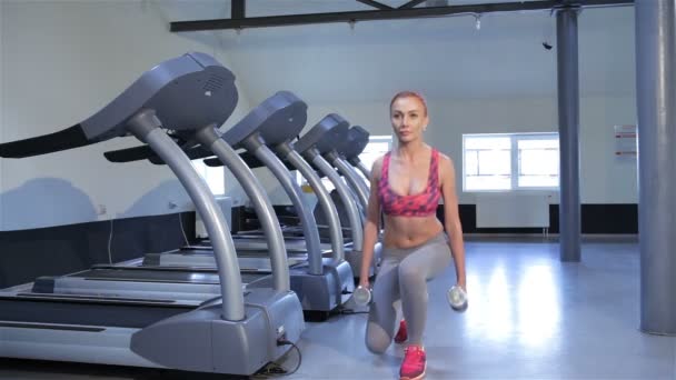 Woman does step-up exercise at the fitness centre — Stock Video