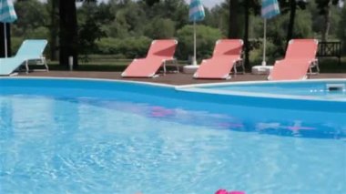 Woman dissolve her hair on the poolside