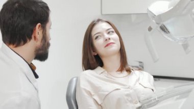 Güzel genç bir kadın dişçiye dişlerini kontrol ettiriyor.