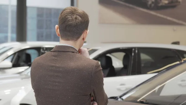 Happy mature man smiling to the camera while choosing car to buy Stock Picture