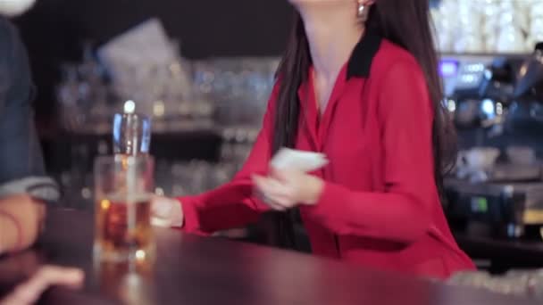 Cute girl at the bar smiling boy in a funny in Santa hat — Stock Video