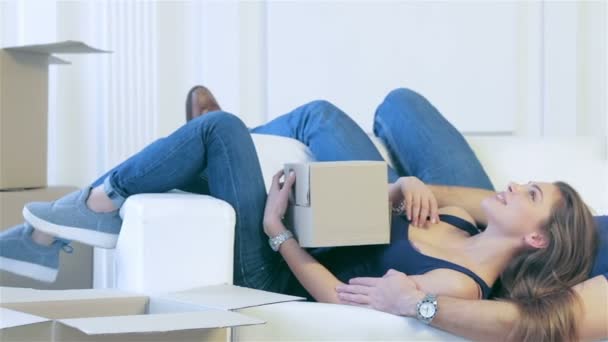 Couple in love lying among the boxes — Stock Video