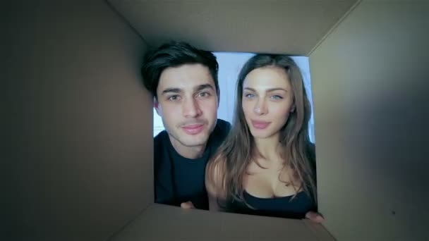 Loving man and woman look in boxes for moving — Stok Video