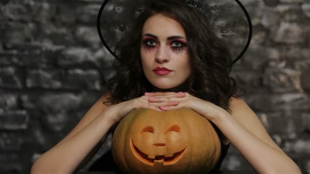 The woman-sorceress posing with pumpkin