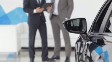 Otomobil fuarındaki satıcı ve alıcı.