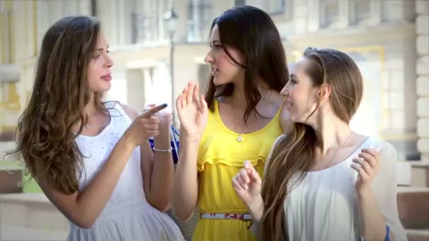 Tres hermosas chicas sonrientes en una tarde soleada en la ventana de una boutique — Vídeos de Stock