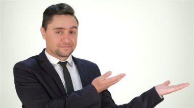 Young smiling grinning man pointing to copyspace