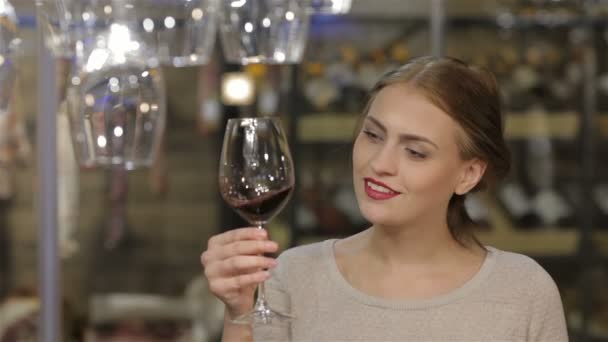 Beautiful young woman drinking wine — Stock Video