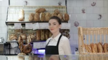 Woman baker smiling new buyer