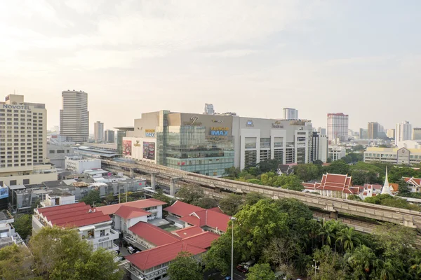 BANGKOK,THAILAND-FEBRUARY 17:Bangkok Mass Transit System (BTS) pass the Pathumwanaram temple at siam in sunny day on February 17,2015