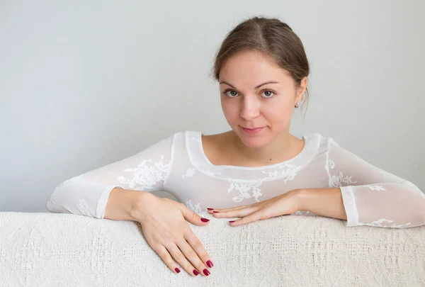 Jonge vrouw die lacht in camera in ontspannen sfeer — Stockfoto