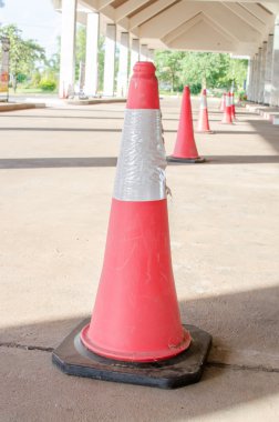 orange traffic cones on the road at the park.