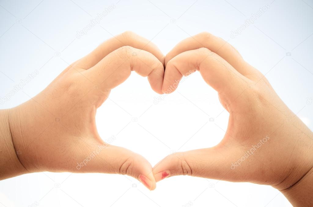 girl holding hands in heart