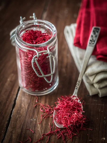 Jar and spoon with saffron — Stock Photo, Image