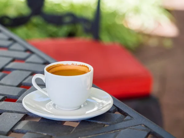 Cup of coffee on a garden table. — Stock Photo, Image